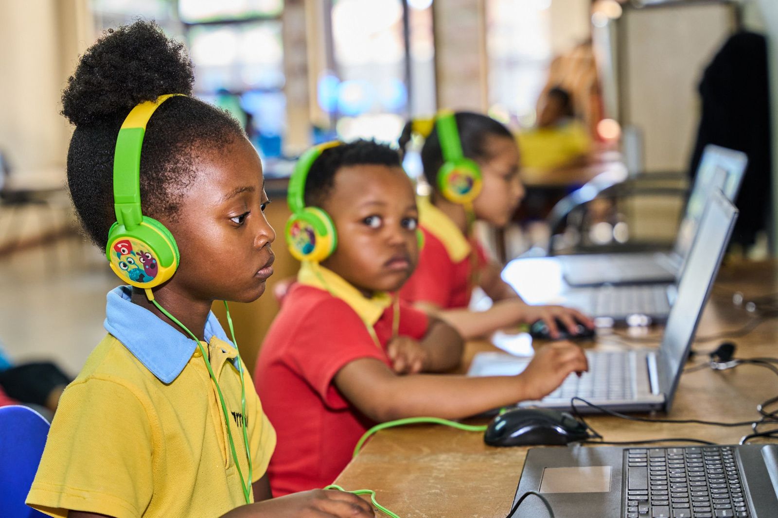 Learners with headphones during a social media campaign shoot