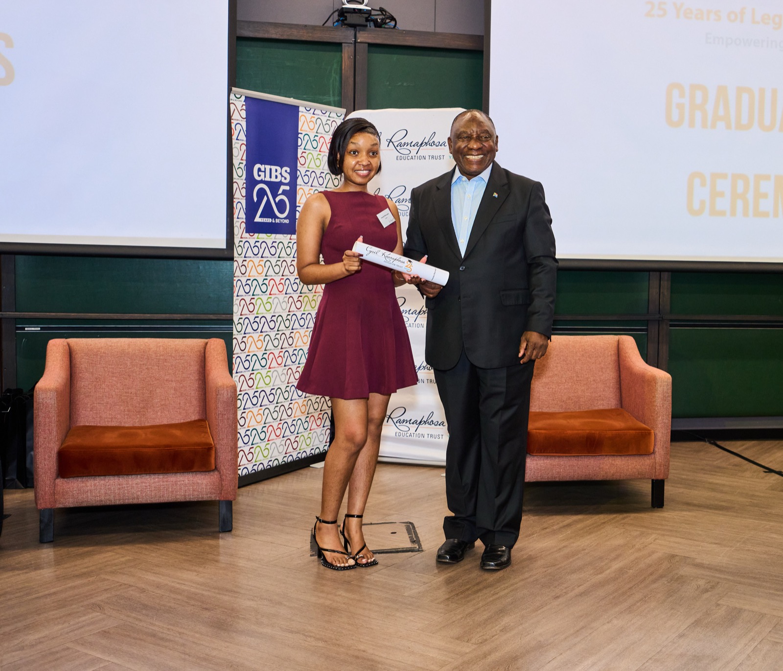 A graduate receiving a certificate on stage