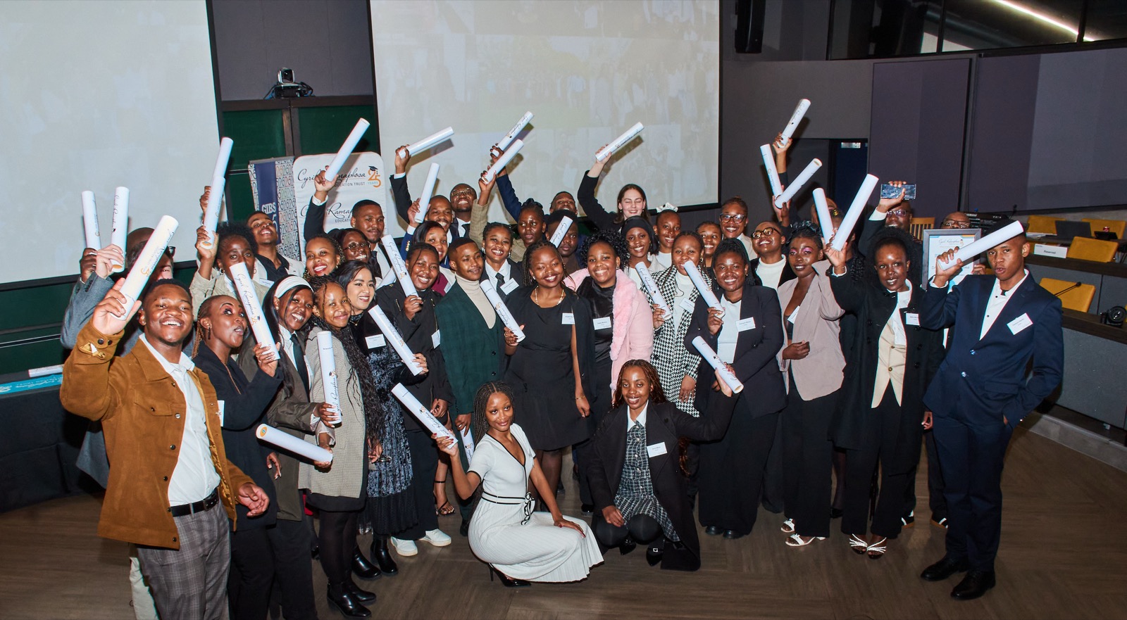 Graduates celebrating with their certificates