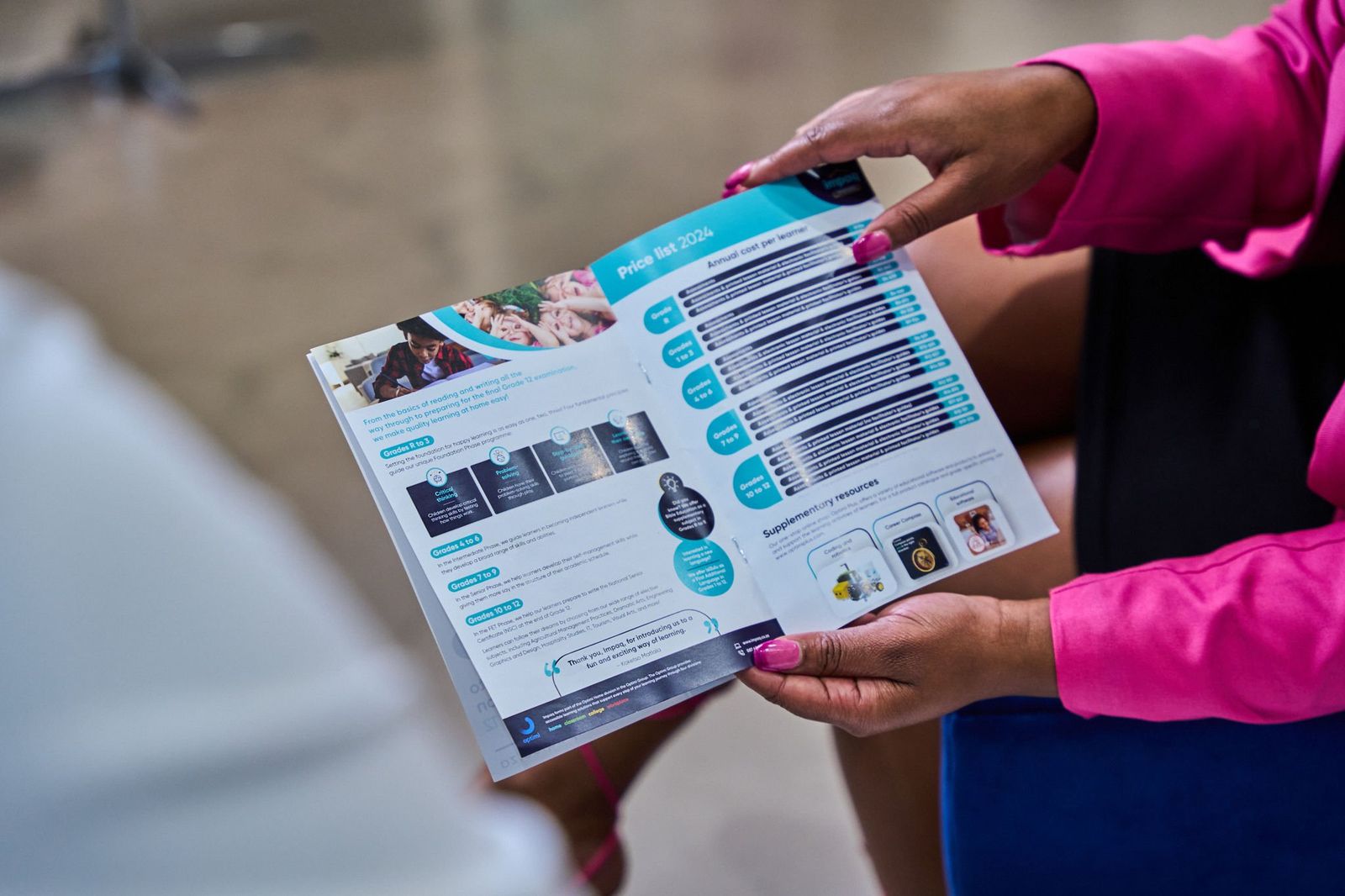 Hands holding a printed brochure